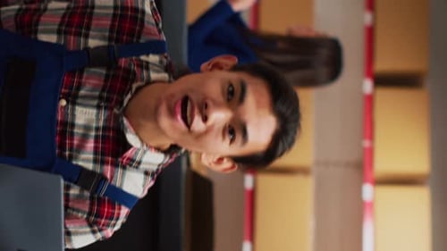 Young Man in Warehouse Talking to Camera