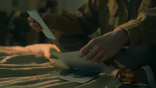 Guy Looking at Photos and Regretting Past Decisions at Night