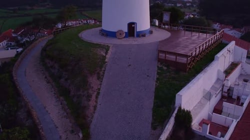 Vue aérienne d'un village traditionnel avec un moulin à vent au lever du soleil, Odeceixe, Portugal.