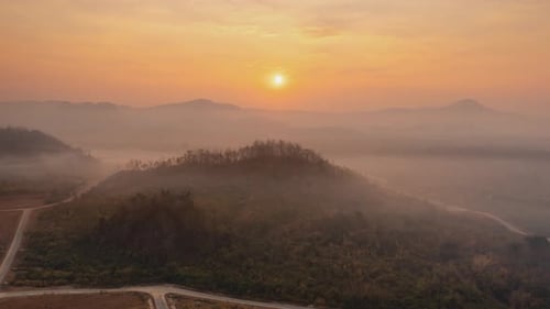 Beautiful aerial view of a mountain with the sun shining golden,