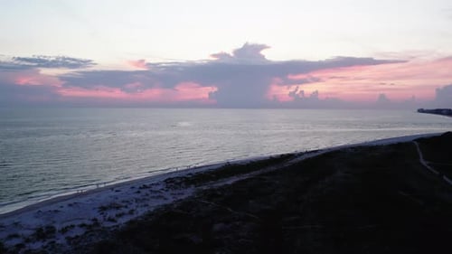 Beautiful Florida sunset in Sarasota. Rising shot over sand dunes. 60 fps