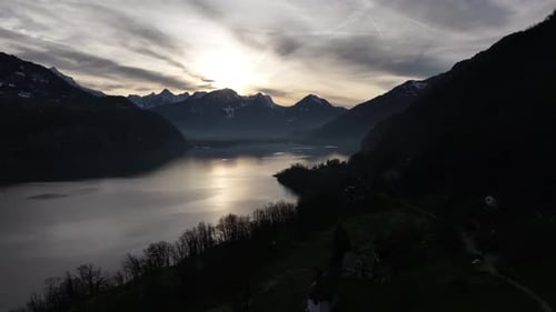 Sunset over serene Walensee and Churfirsten peaks, Switzerland - aerial