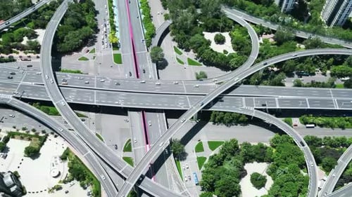 Aerial view of circular viaduct road multilevel interchange overpass or highway intersection with bu