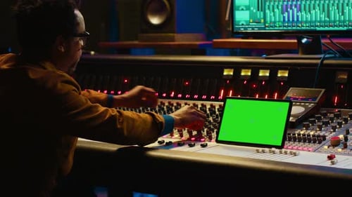 Professional Audio Technician Recording Tracks with Mockup on Tablet