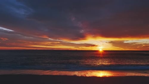 Sunset Over Sea with Vibrant Red and Orange Sky
