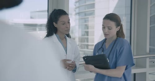 Healthcare Professionals Discussing Patient Data in Hospital