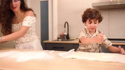 Woman and Boy Baking Pastries in Kitchen