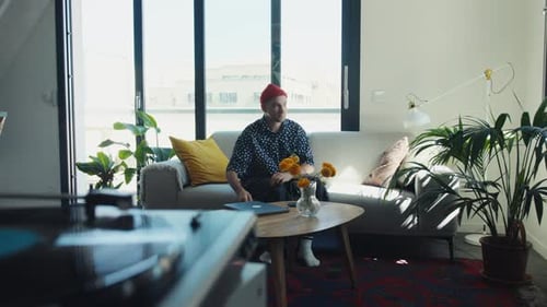 Young Adult Relaxing on Couch with Laptop