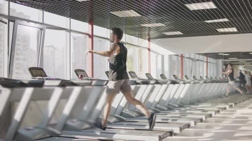 Run Workout in Gym. Man Training Exercise on Treadmill. Muscular Male Person