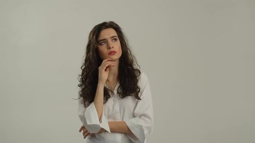 Young Woman Thinking with Finger on Chin
