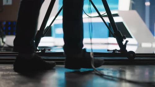Studio Camera Tripod with Operator's Feet Dolly and Cables in TV Studio