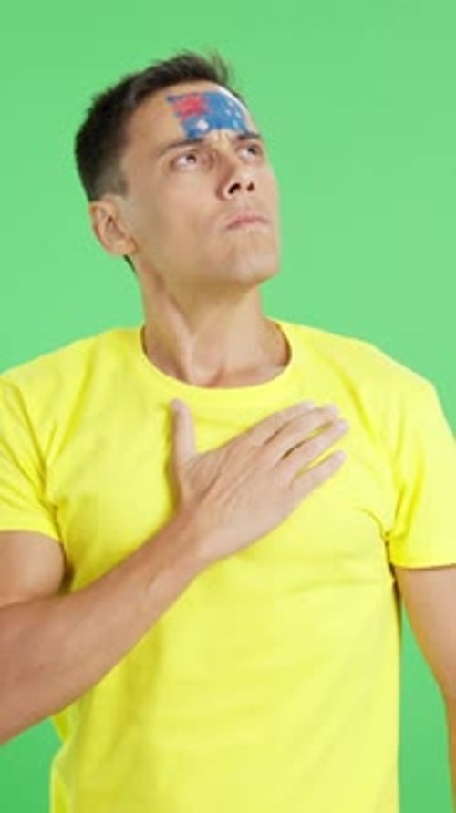 Man Listening to the Australia National Anthem with Solemnity