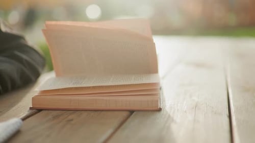 Book on Wooden Table with Pages Turning