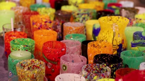 Close up shot of many beautifully handcrafted colorful glass cups