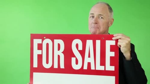 Senior caucasian business man green screen happy with for sale sign