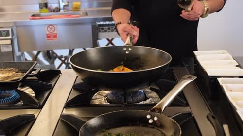 Chef Tossing Vegetables in Commercial Kitchen