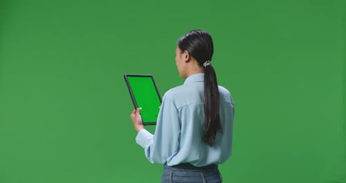 Back View Of Business Woman Using Tablet With Mock Up Green Screen On Green Screen Background