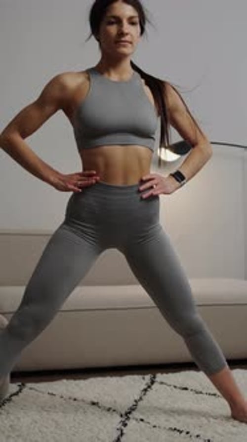 Woman Stretching in Home on Rug