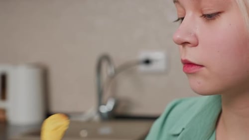 Close Up Fair Skin Girl Eating Chips with Blurred Kitchen Background