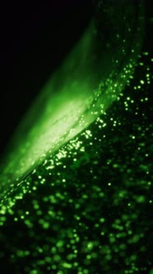 Green glowing particles in glass geometry