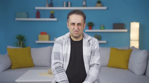 The man is disgusted.