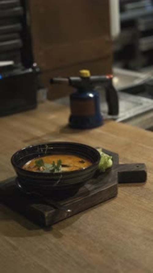 a bowl of soup on a restaurant serving table, vertical video
