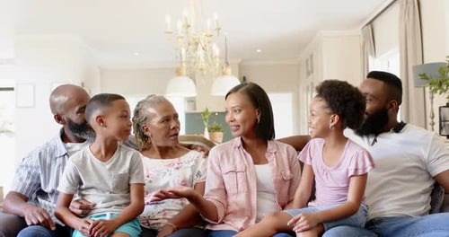 Family Bonds: Generations Share Laughter on Living Room Couch