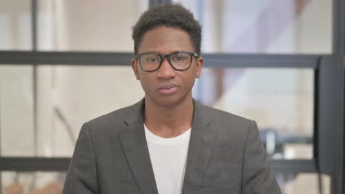 Young Adult Wearing Glasses Looking at Camera