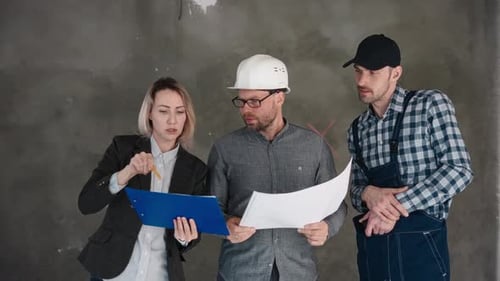 Architects and Engineers Reviewing Plans on Construction Site