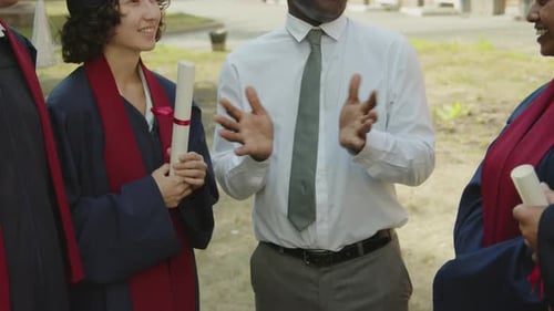 Teacher Talking to Students about Future Career after Graduation Ceremony