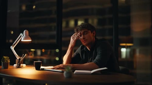 Man working late in office at night