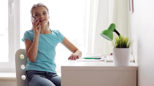 Teen girl talking on the phone in bedroom