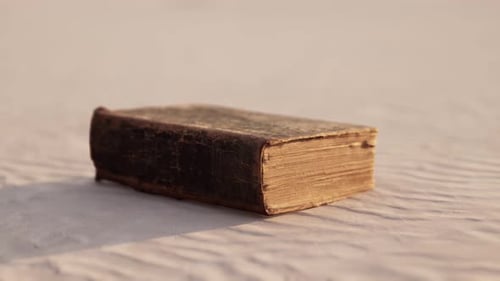 Old Book on the Sand Beach