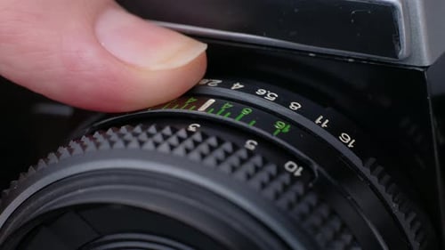Finger Adjusting Focus on Camera Lens