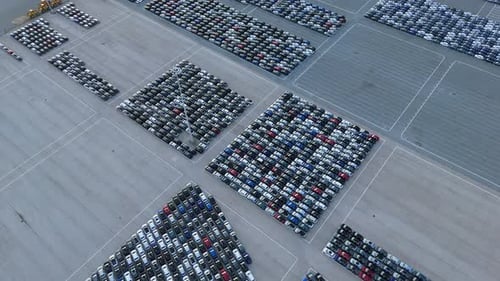 New Cars on Half Empty Large Parking Lot in Port Aerial View