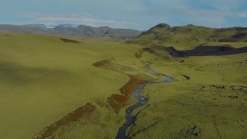 Untouched green fields and clean blue river streams in the middle of Iceland.