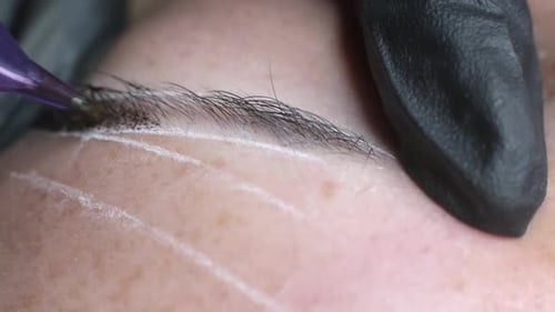 Close Up of Cosmetologist Applying Eyebrow Tattoo