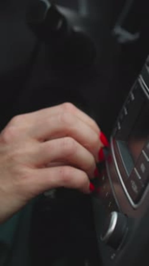 Woman Turns on Air Conditioning System in Car with Hand