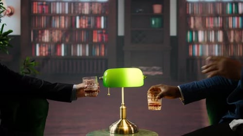 Men in Suits Toasting Glasses in Library Setting