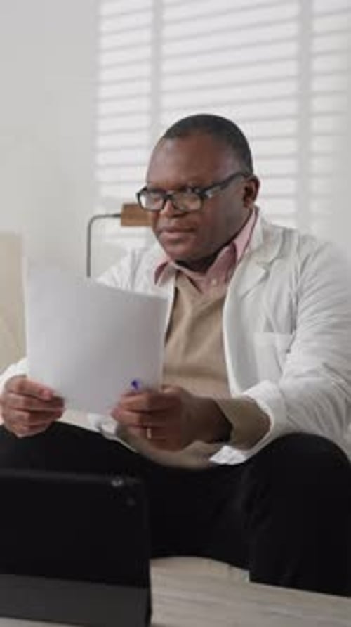 Professional Therapist or Surgeon Consulting Patient in Office of Clinic Vertical Portrait of