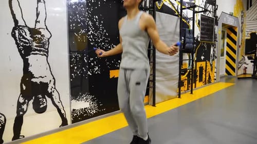 Young Sportsman Skipping with a Jump Rope at Modern Gym Athletic Guy in Sportswear Doing Cardio at
