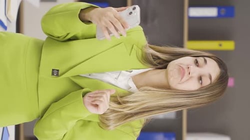 Vertical video of Businesswoman liking phone app.