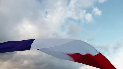 French Flag Waving Against Cloudy Sky