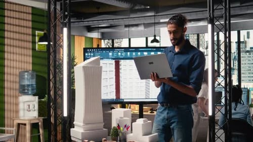 Male Real Estate Engineer Studying Smart City Design and Buildings Layout