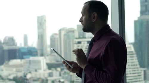 Man working on tablet in modern office setting