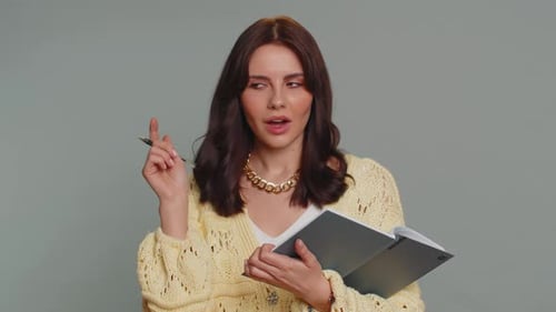 Woman Has Great Idea Writing in Notebook