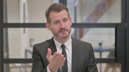 Confident Man Delivering Business Presentation in Modern Office
