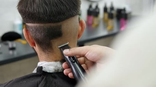 Barber Trimming Hair with Clippers Close Up