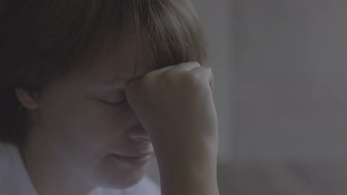 Close Up of a Sad Girl Resting Head on Fist with Eyes Closed