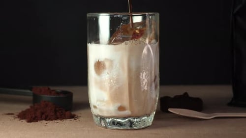 Preparing Delicious Iced Coffee Drink with Milk